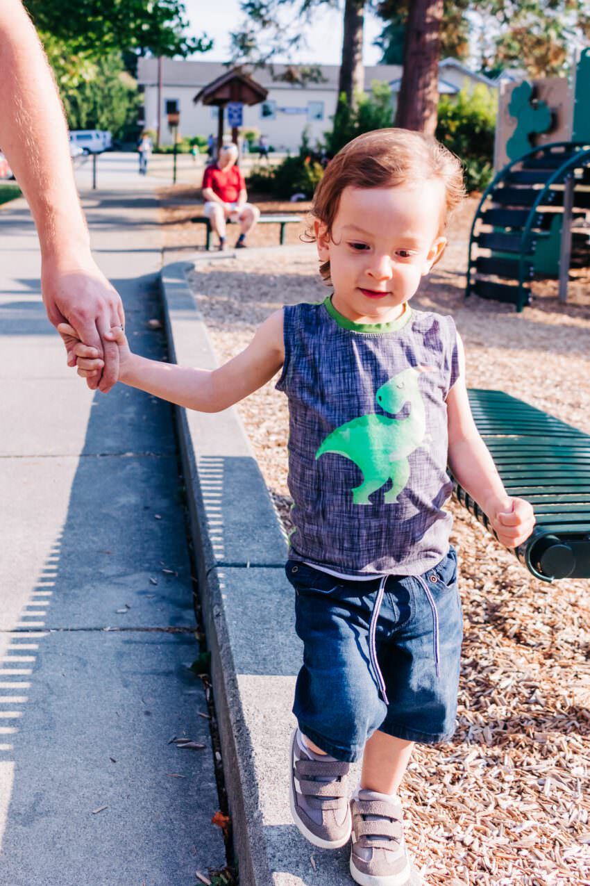 A two year old in a dinosaur tank top