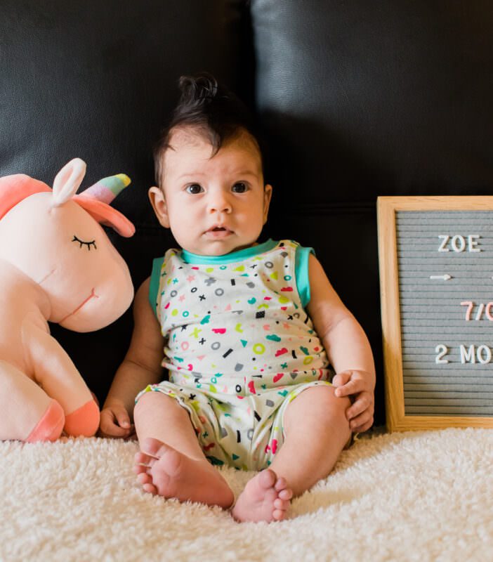 A baby in a bright romper